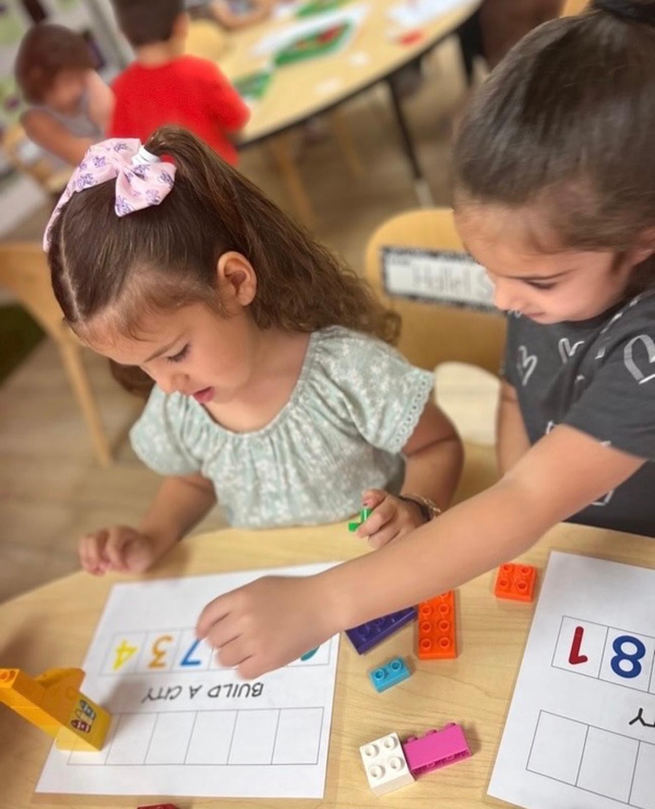 Two children counting with blocks